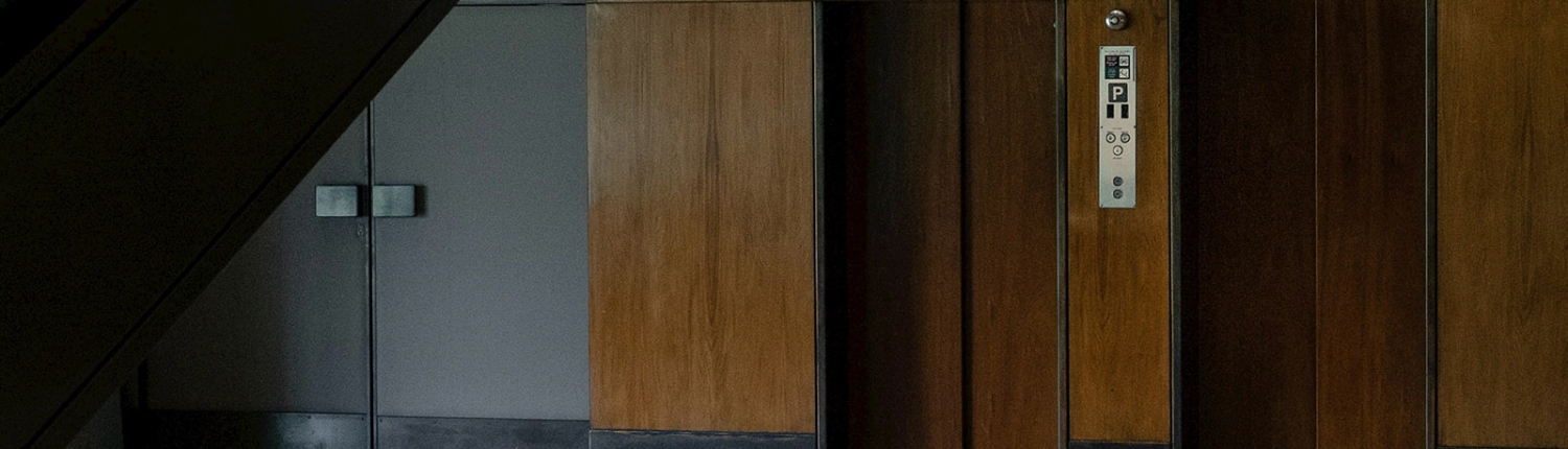 Wood panelled elevator doors in an office lobby