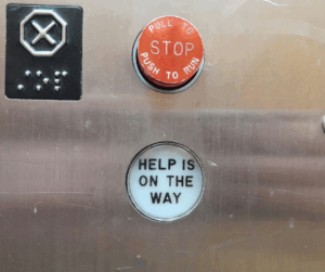 Elevator button reading Help is on the way
